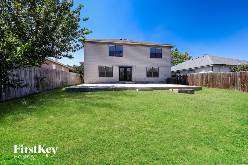 A house with a lawn in front of it.