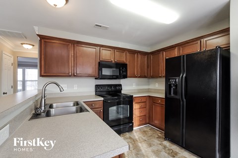a kitchen with black appliances and white counter tops