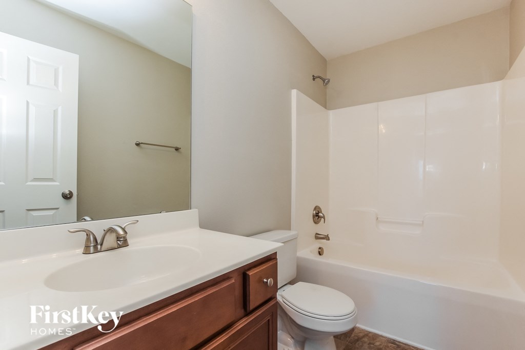 a bathroom with a sink and a toilet and a bath tub