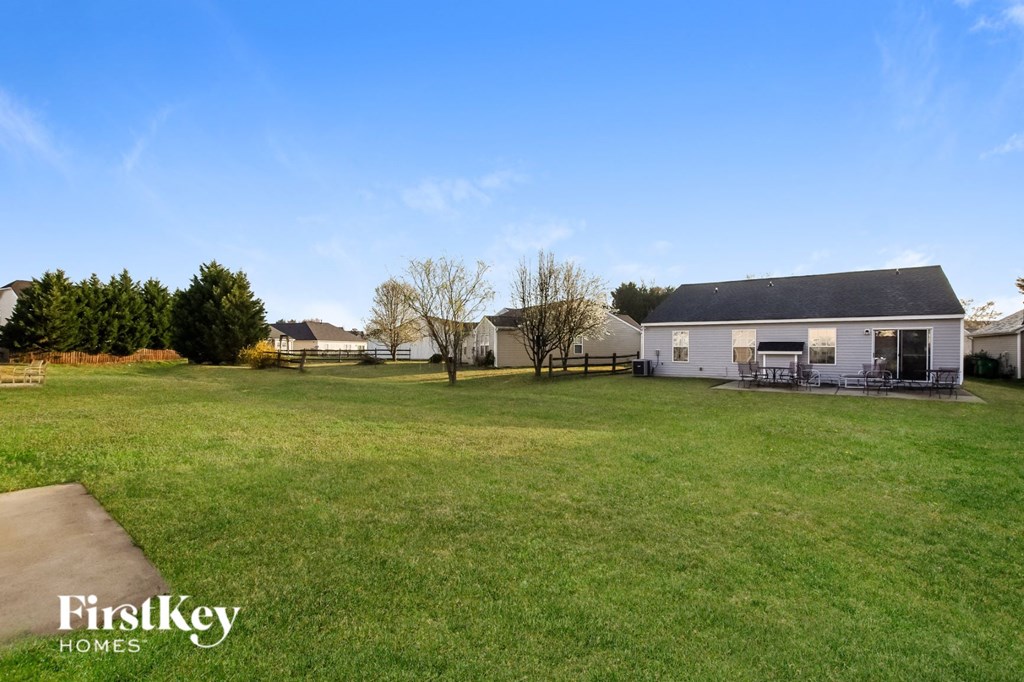 a large yard in front of a white house