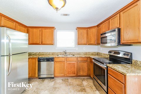 a kitchen with wooden cabinets and stainless steel appliances
