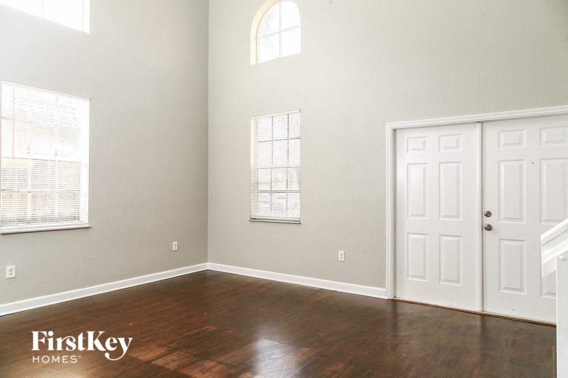 A room with a wooden floor and a white door.