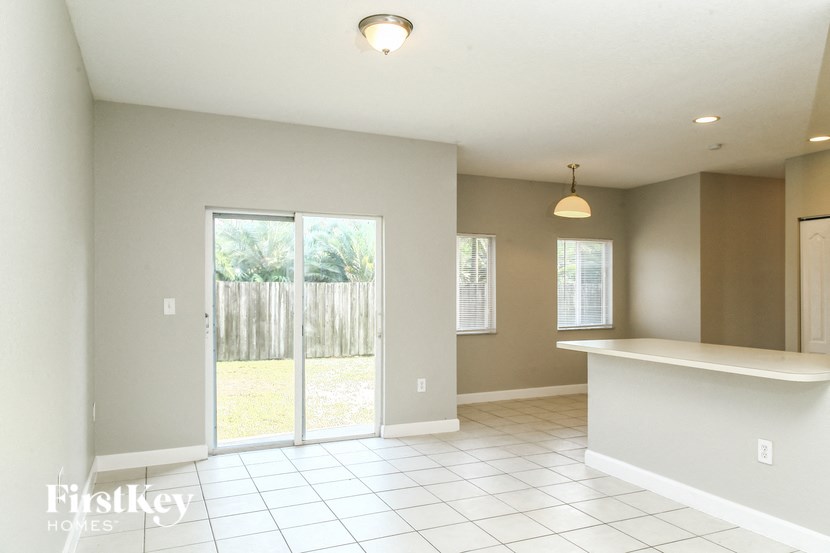 A large empty room with a sliding glass door.