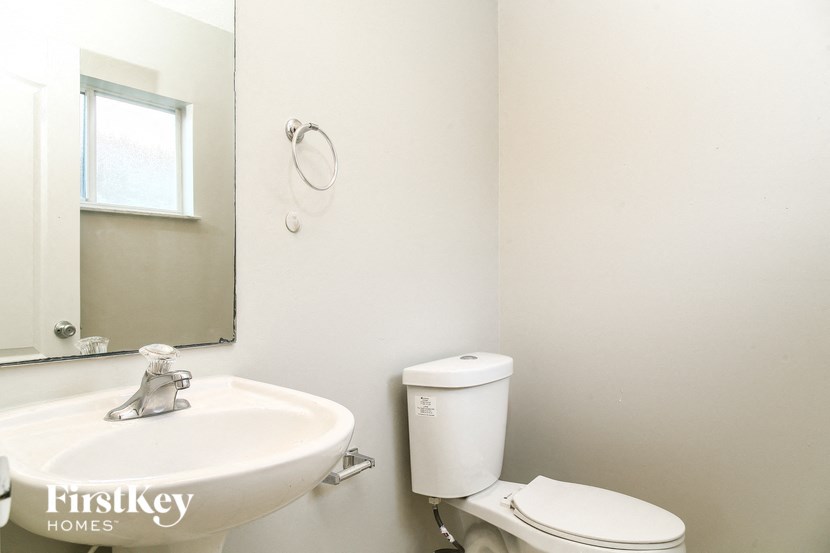 A white toilet sits next to a sink in a bathroom.