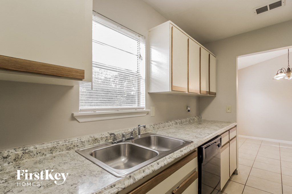 an empty kitchen with a sink and a window