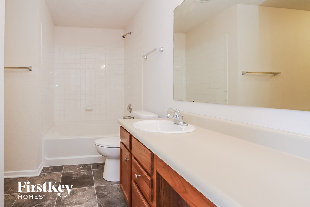 a bathroom with a sink and a toilet and a tub