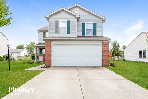 a white garage door in front of a house
