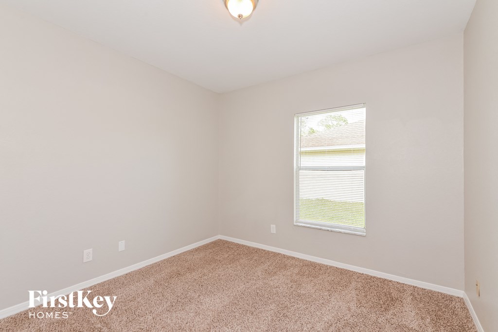 the second bedroom with carpet and a window