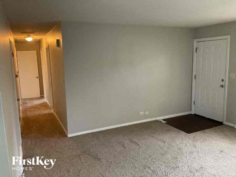 a living room with a white carpet and a white door