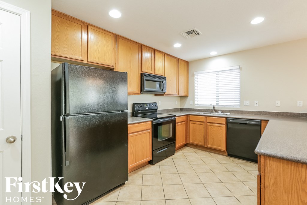 a kitchen with black appliances and wooden cabinets