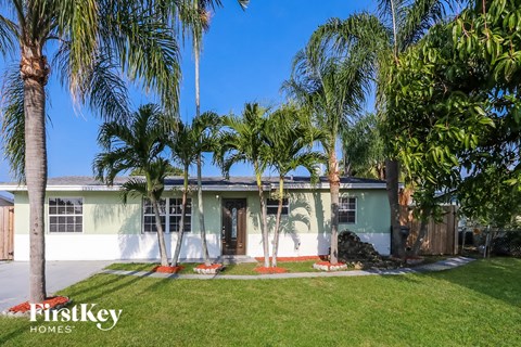 a house with palm trees in front of it