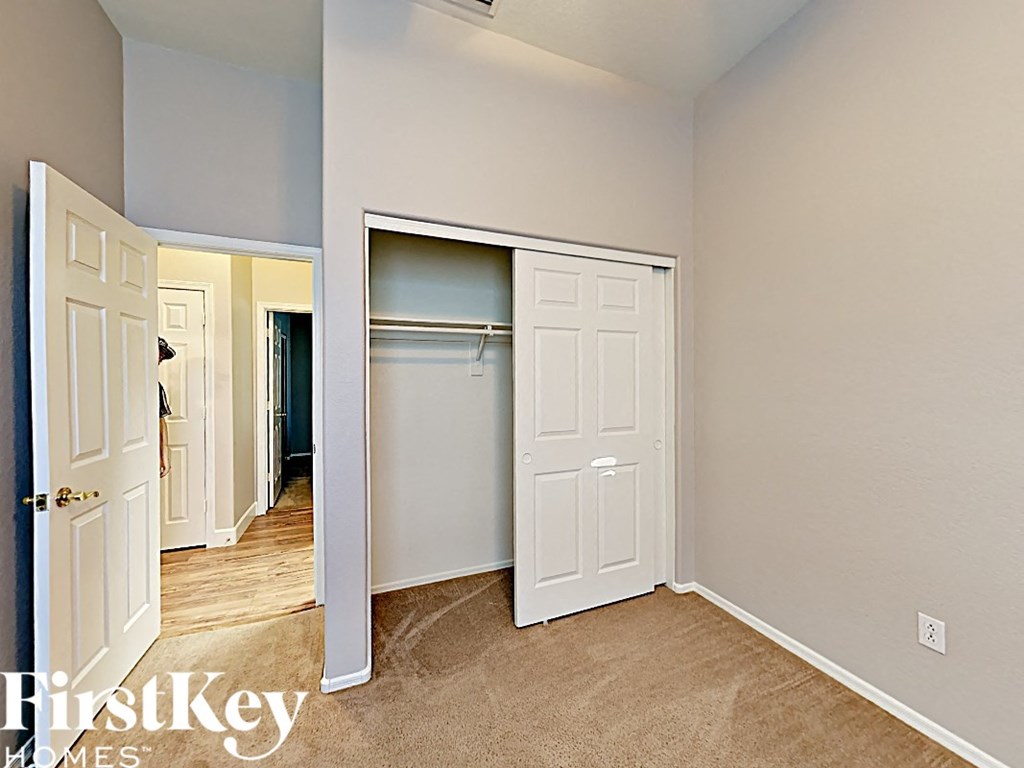 a bedroom with a closet and an open door to a closet
