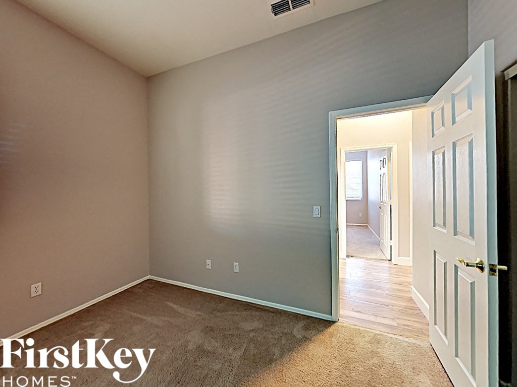 a bedroom with a door open to a hallway and a door to a closet