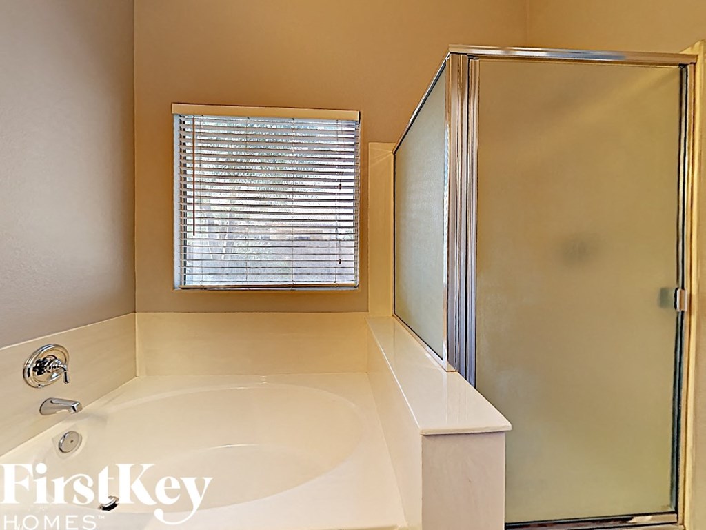a small bathroom with a tub and a shower