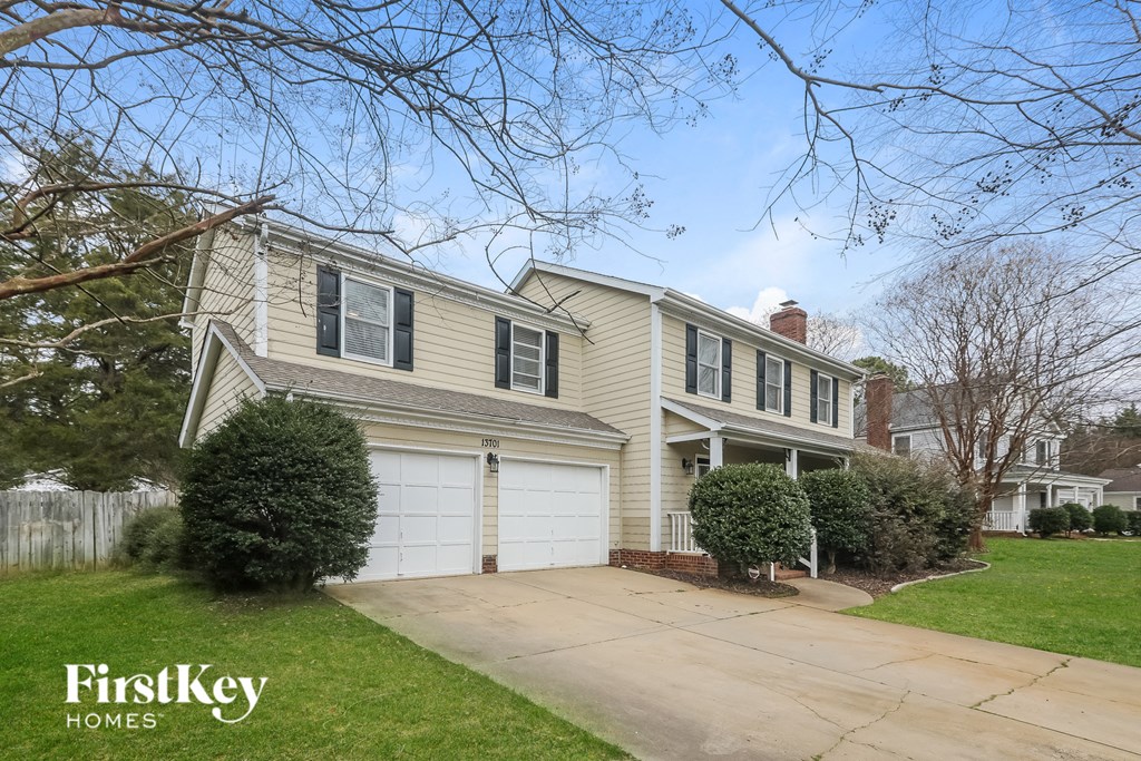 a yellow house with a white garage door