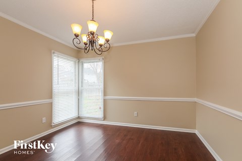 a dining room with a chandelier and a window