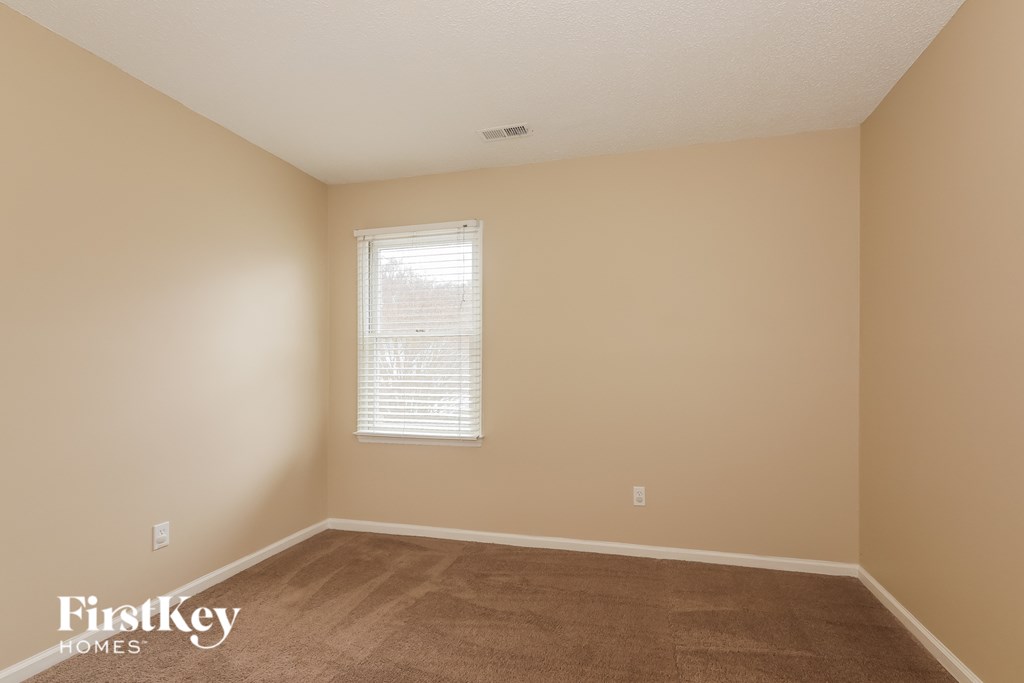 a room with a carpeted floor and a window
