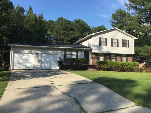 A house with a driveway in front of it.