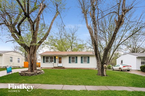 A house with a tree in front of it.