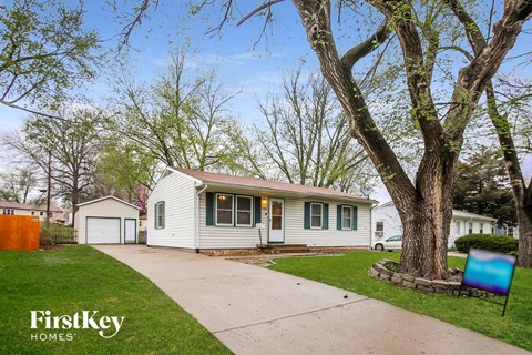 A house with a tree in front of it.