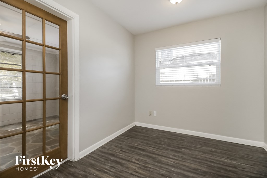 a bedroom with a door to a closet and a window