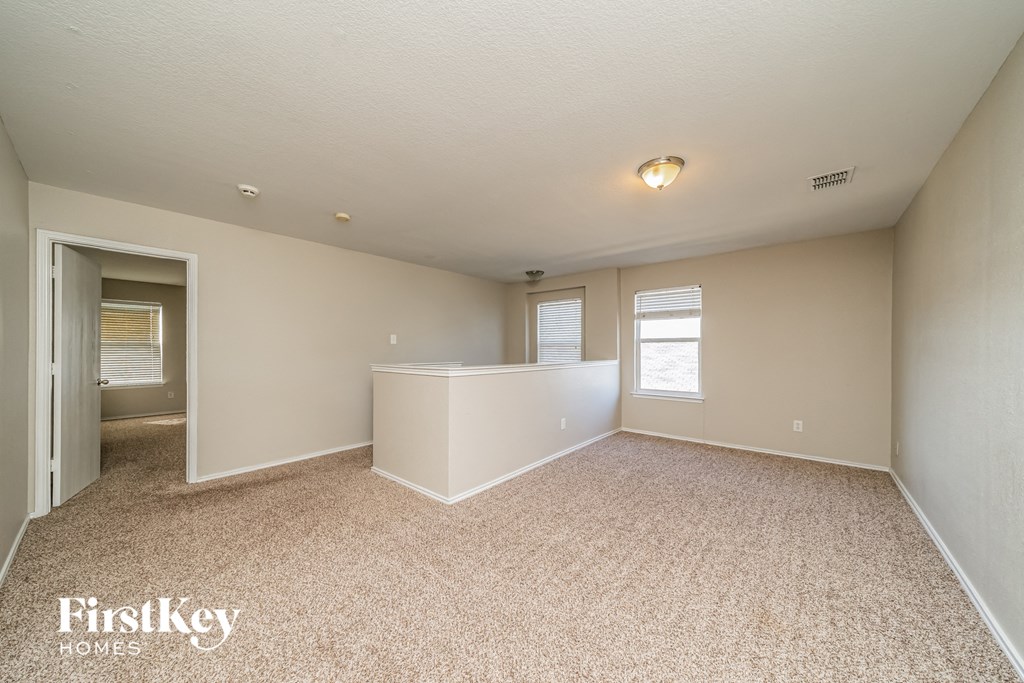 the living room and dining room of an empty house