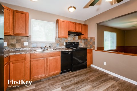 a kitchen with black appliances and wooden cabinets
