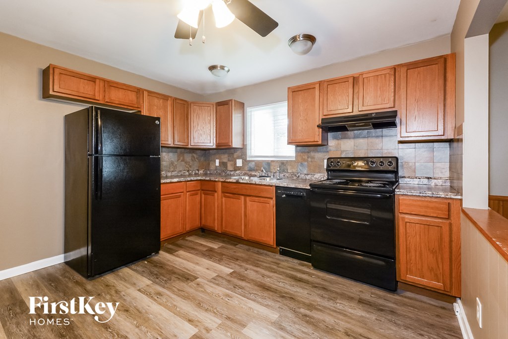 a kitchen with black appliances and wooden cabinets