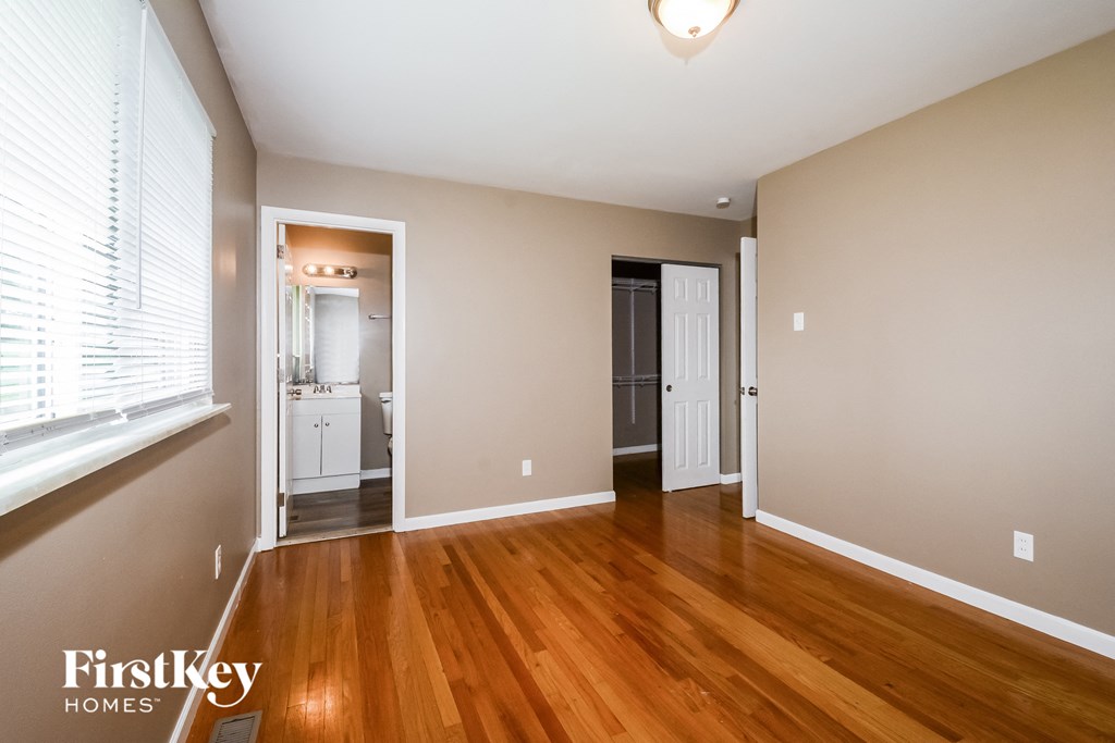 a living room with wood flooring and a large window