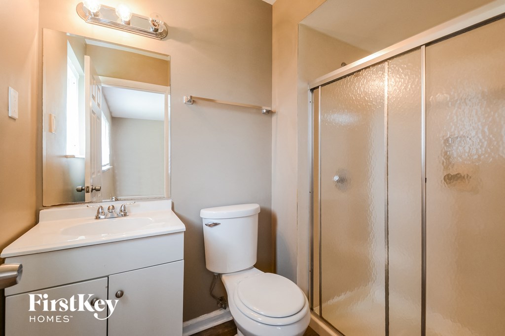 a bathroom with a toilet sink and a shower