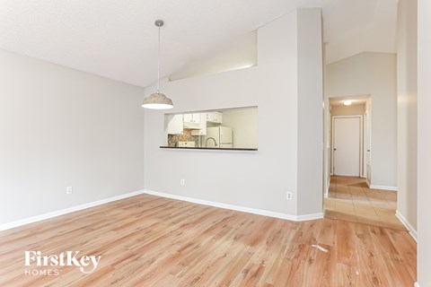 the living room and dining room with hardwood flooring