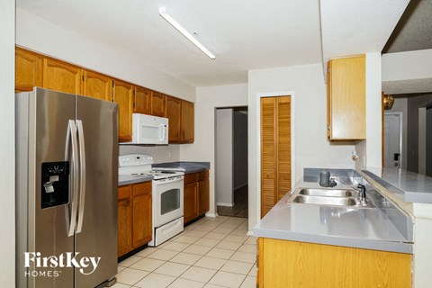 a kitchen with wooden cabinets and stainless steel appliances and a sink