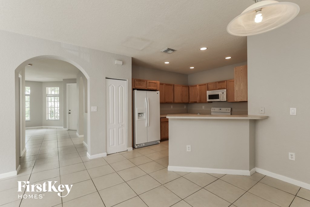 a kitchen with a counter top and a refrigerator