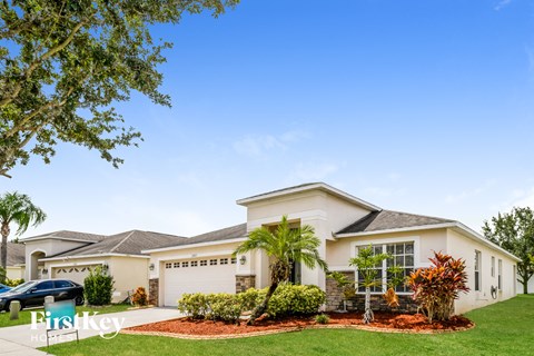 a house with palm trees in front of it