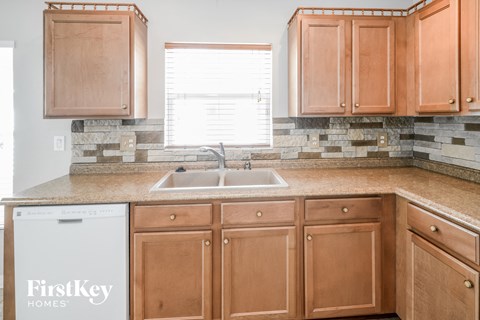 a kitchen with wooden cabinets and a sink