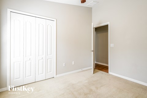 a bedroom with two closets and a door to a hallway
