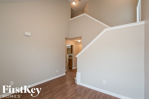 A room with a staircase leading to another room.