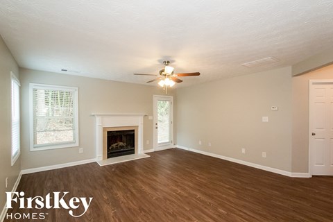 A room with a fireplace and a ceiling fan.