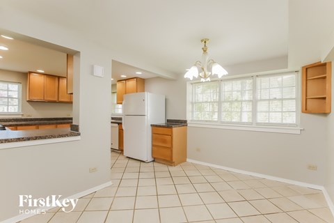 a kitchen with a white refrigerator and a sink