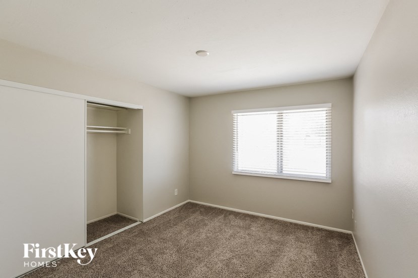 a bedroom with a closet and a window