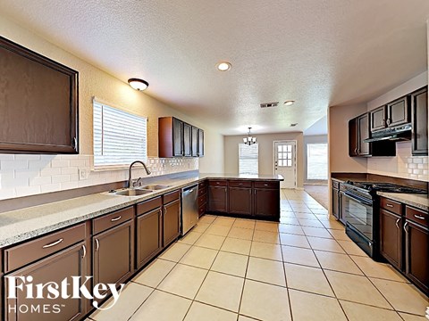 A kitchen with brown cabinets and a white counter top.