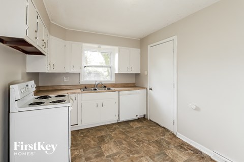 A kitchen with a stove top oven and a dishwasher.