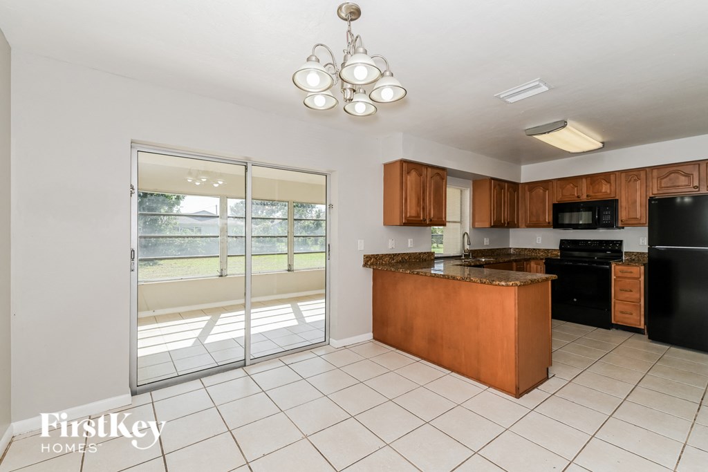 a large kitchen with a sliding glass door to the patio