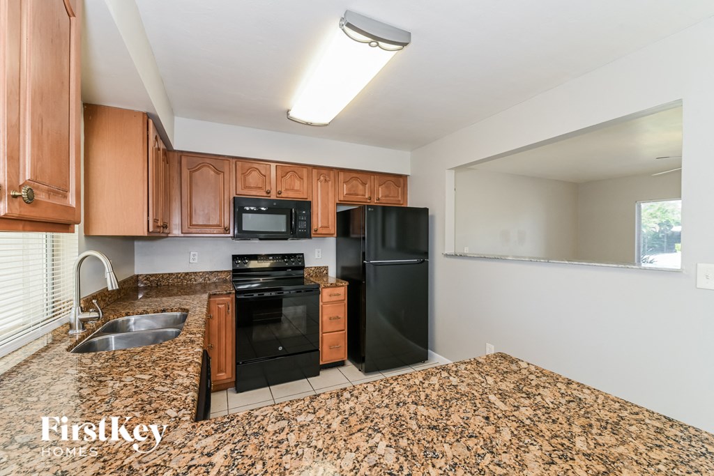 a kitchen with black appliances and granite counter tops