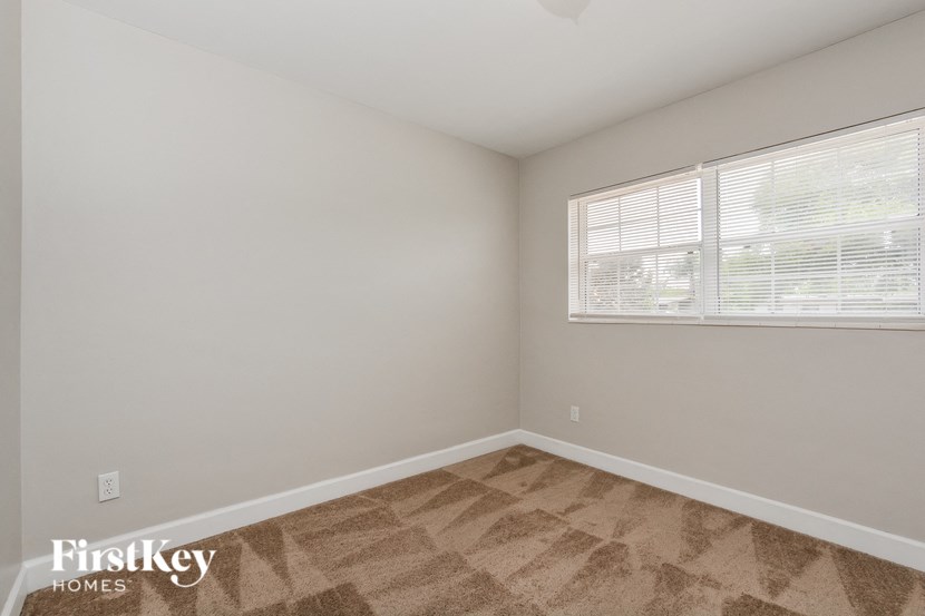 the living room of an apartment with a large window