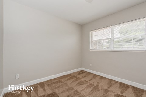 the living room of an apartment with a large window