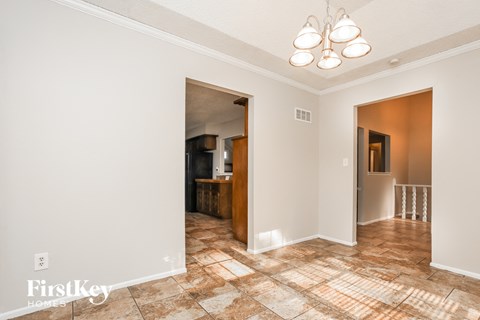 A room with a tiled floor and a chandelier.