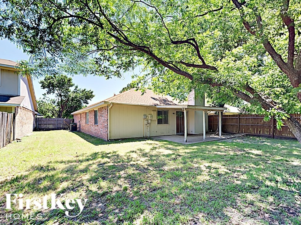 A house with a tree in front of it.