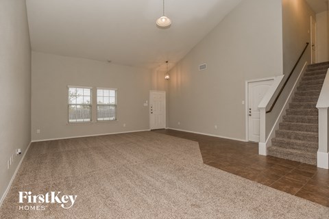 the spacious living room with stairs to the second floor