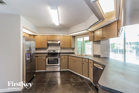 a kitchen with stainless steel appliances and wooden cabinets